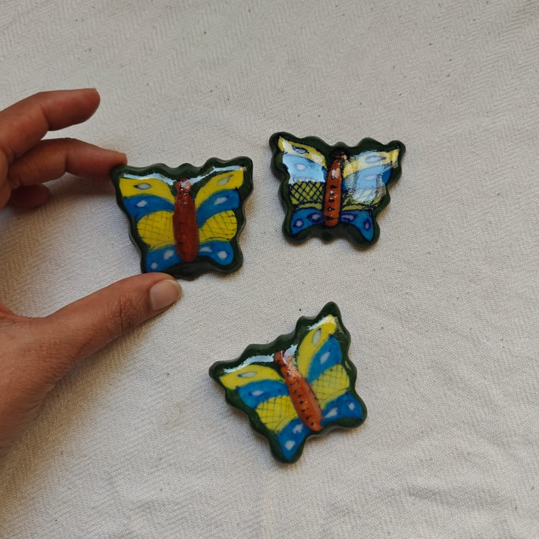 Three colorful butterfly-shaped ceramic magnets 